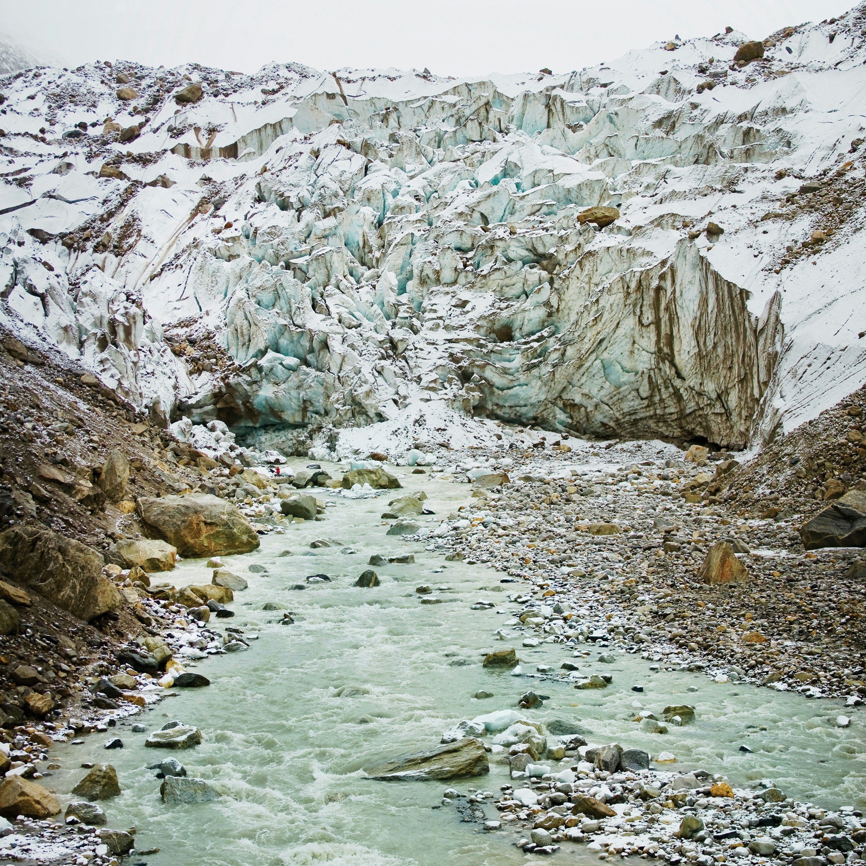 rocky river between rocky mountains during daytime